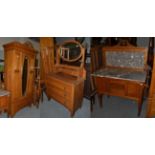 An early 20th century oak three piece bedroom suite; comprising a marble top washstand, mirrored