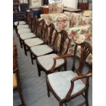 A set of eight Hepplewhite style carved mahogany dining chairs including a pair of carver armchairs