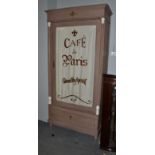 A painted cabinet in the French taste, the glazed door painted Cafe de Paris grand vin aperitif,