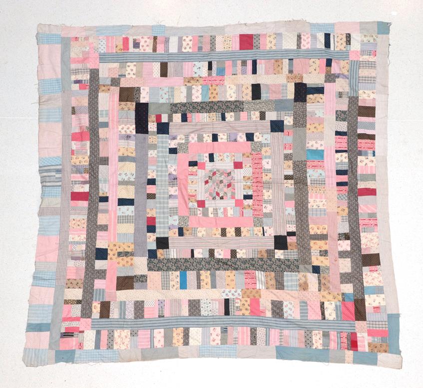 A 19th Century Patchwork Cover, comprising a central square within frames of rectangles and stripes,