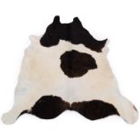 Skins/Hides: A Cow Hide Rug (Bos taurus), modern, a dark brown and white patterned cow hide rug,