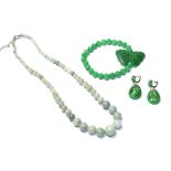 A graduated jadeite necklace, clasp stamped '925', length 47cm, an elasticated jadeite bracelet