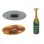 A Mdina glass bottle vase, 33cm, an amber moulded glass dish, 39cm and a smokey glass pedestal