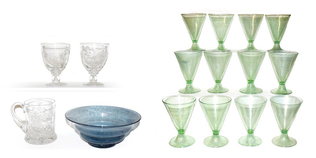 A set of twelve Continental green cocktail glasses, of trumpet form and each raised on folded