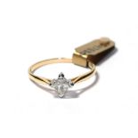 A diamond solitaire ring, the princess cut diamond in a white four claw setting, to a yellow tapered