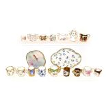 A tray of miniature porcelain tankards and dolls house miniatures, including Royal Crown Derby,