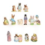 Ten Beatrix Potter figures including some gold back stamps, Royal Doulton miniature jug and a pair