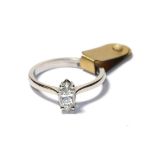 A diamond solitaire ring, the marquise cut diamond in a white claw setting, to a tapered shoulder