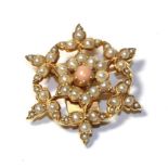 A coral and split pearl brooch, the central round cabochon coral within a border of split pearls, to