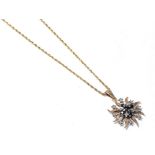 A sapphire and diamond pendant on chain, the starburst motif set throughout with round cut sapphires