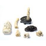 Two Japanese Meiji period carved ivory netsukes, a similar small carving, a modern bone scent