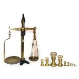A set of Victorian brass and iron W & T Avery shop weighing scales, together with a set of graduated