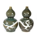 A pair of Chinese porcelain double gourd vases, late Qing/Republic period, with carved white slip