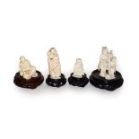 Four Japanese Meiji period ivory carvings on wooden plinths, one a netsuke formed as a boy and