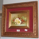 A gilt framed ceramic rectangular plaque, still life berries and flowers, signed, 15cm by 20cm
