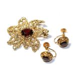 A 9 carat gold garnet brooch, length 3.7cm and a pair of garnet earrings, stamped '9CT', with