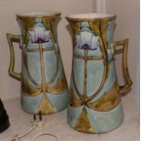 A pair of Minton Secessionist No.13 jugs, with tube lined stylised decoration in green, turquoise