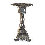 An Elkington & Co silver plated centre piece adorned with fruiting vines and raised on scroll