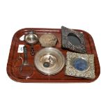 A collection of silver items to include two repousse easel photograph frames, four pin dishes, an