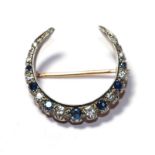 A sapphire and diamond crescent brooch, set throughout with graduated round cut sapphires and
