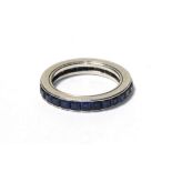 A sapphire eternity ring, the calibré cut sapphires in a white channel setting, finger size I. The