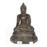 A Sino-Tibetan cast metal sculpture of a Buddha raised on a lotus plinth, 30cm