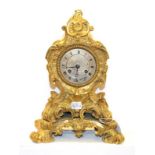 A 19th century French gilt bronze mantel clock in the Rococo style, with silvered dial and Roman