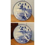 A large pair of Japanese blue and white chargers painted in underglaze blue with mountainous