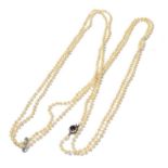 A seed pearl necklace knotted to a sapphire and diamond cluster clasp with a diamond set spacer,