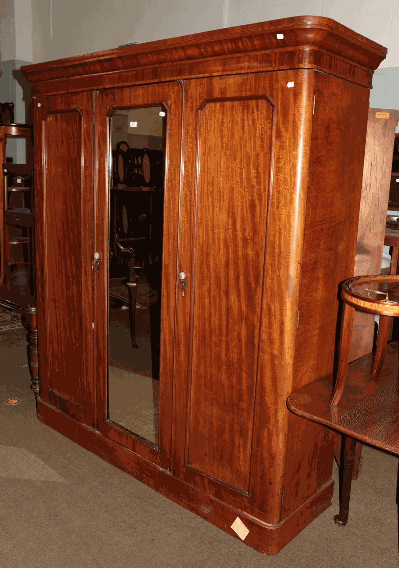 A Victorian mahogany mirror front triple wardrobe with fitted centre section, 174cm by 50cm by 205cm