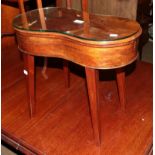 A 19th century mahogany kidney shaped bidet raised on splay supports, 31cm by 55cm by 47cm