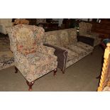 A Queen Anne style carved walnut upholstered three part suite, comprising a three seater settee