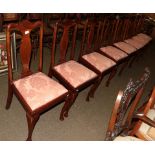 A set of eight carved mahogany dining chairs raised on plain cabriole supports (8)