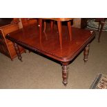 A Victorian mahogany wind out dining table with one additional leaf, raised on turned supports,