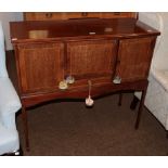 An Edwardian mahogany sideboard with strung inlay raised on slender square tapering supports,