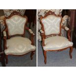 A pair of French style gilt carved salon armchairs