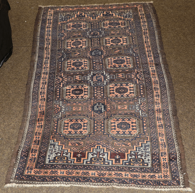 Baluch Rug, North East Iran, circa 1900 The chocolate brown field with two columns of Salor güls and