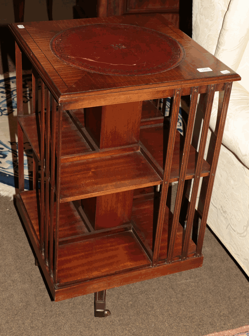 An mahogany and leather revolving bookcase