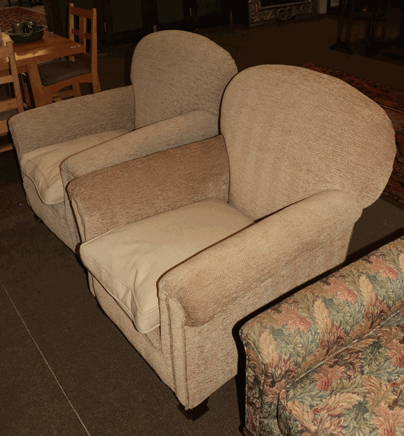 A pair of upholstered armchairs, raised on mahogany block feet (2)