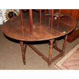 An early 19th century oak gateleg dining table, 148cm by 123cm by 73cm high