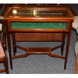 A Victorian mahogany bijouterie table, cross-banded in satinwood raised on square tapering supports,