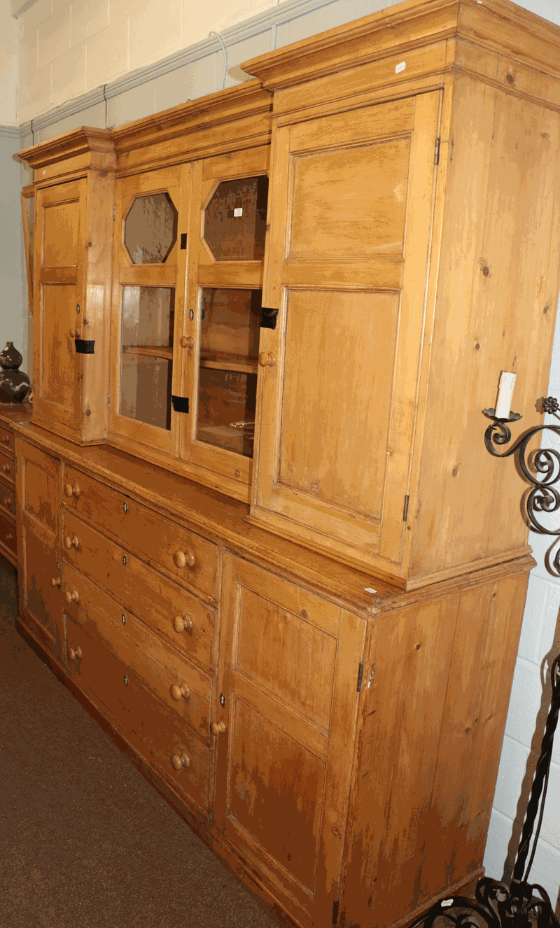 An early 19th century pine kitchen dresser / housekeepers cupboard with glazed reverse break front