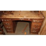 An early 20th century oak twin-pedestal desk, formerly a roll top desk, 125cm by 74cm by 78cm