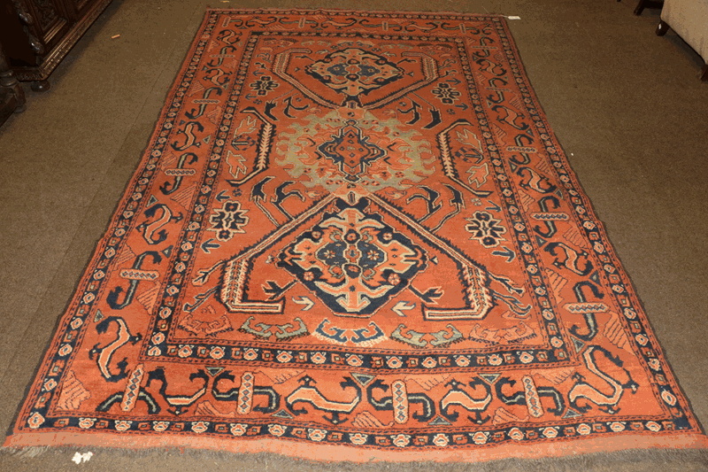Afghan Carpet, the terracotta field with central medallion framed by 'S' motif borders, 286cm by