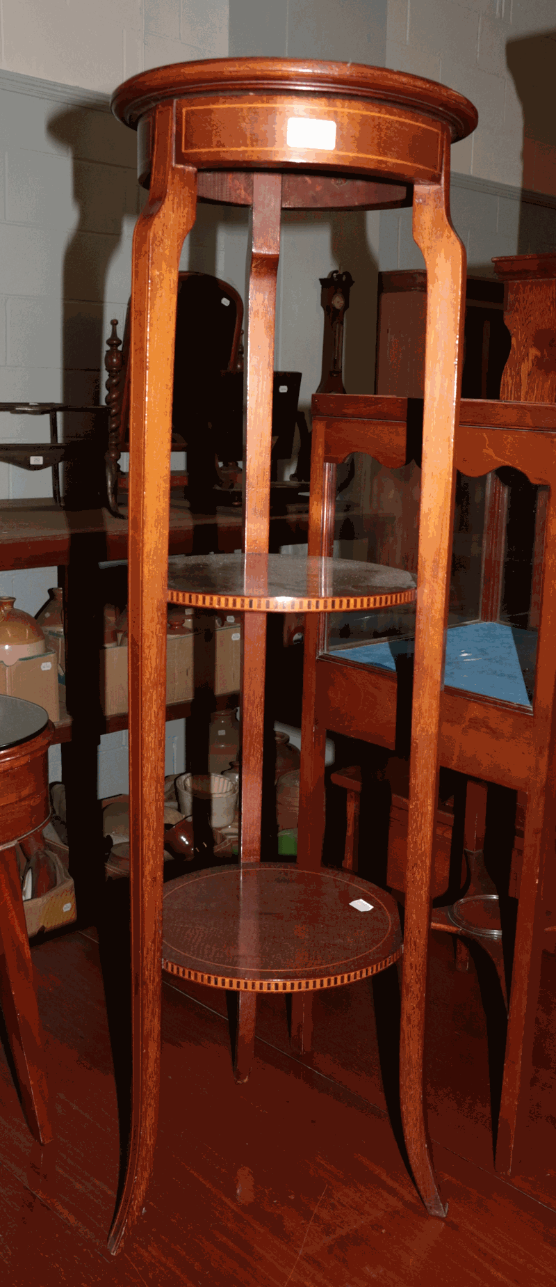 An Edwardian inlaid mahogany circular plant stand, 109cm high