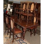 A carved oak dining table, 148cm by 104cm by 74cm together with six cane dining chairs, circa