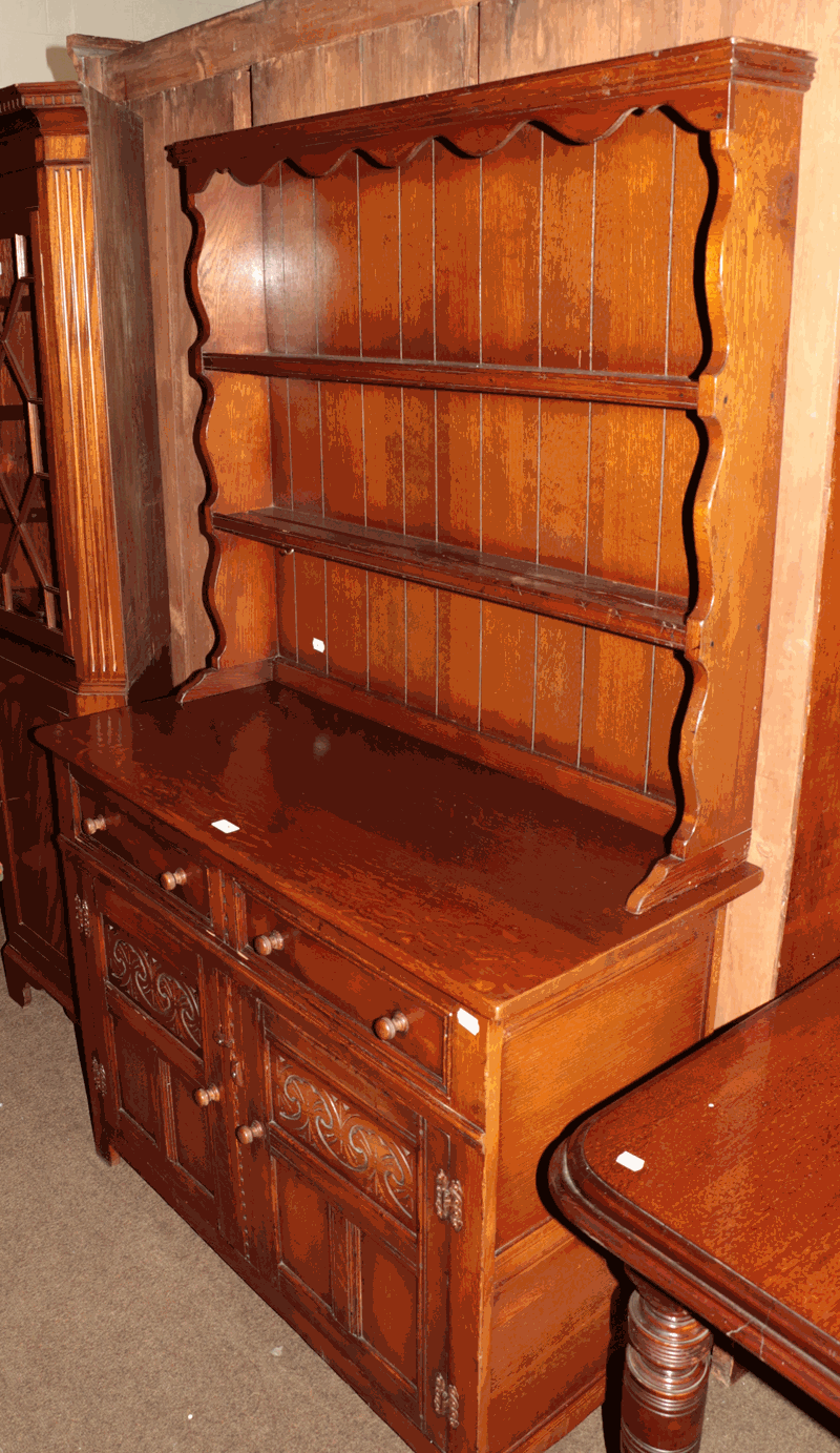 A 20th century oak dresser and rack, bearing label J H Hesketh & Son. Ltd. Burnley, 107cm by 47cm by
