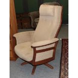 A retro teak framed swivel armchair