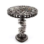 a Steampunk Industrial metal tripod table, constructed using various industrial sprockets, gears,