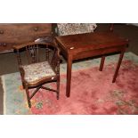 A George III mahogany fold over tea table, raised on square supports, 88.5cm by 43cm by 73cm